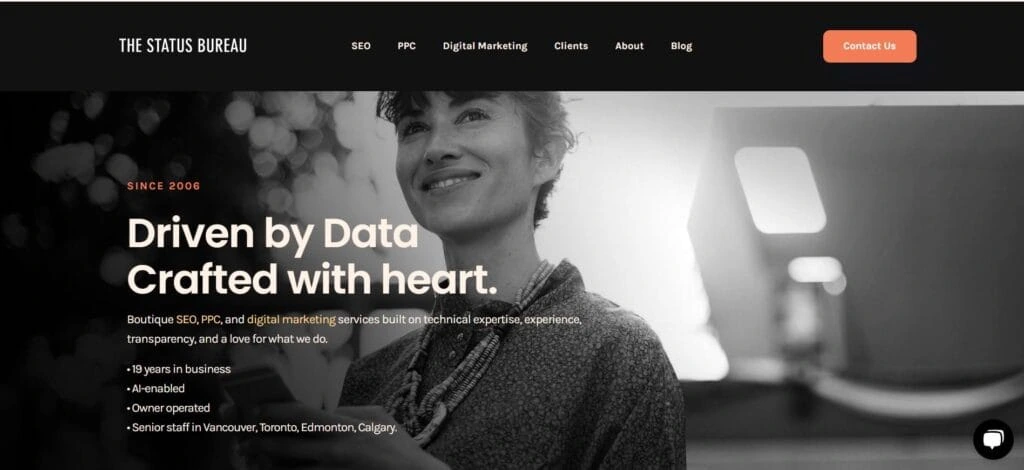 The Status Bureau homepage featuring a black-and-white image of a smiling woman with the tagline “Driven by Data, Crafted with Heart,” emphasizing boutique SEO and digital marketing.