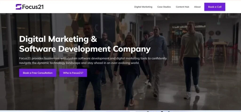 Homepage of Focus21 showing a team walking in a modern office, with the headline “Digital Marketing & Software Development Company.”