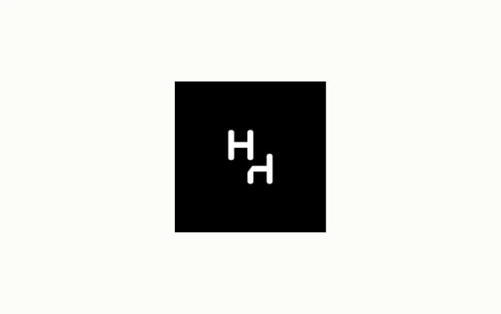 "Minimalist black square logo with two white stylized 'H' letters, one upright and one rotated, creating a mirrored and modern visual identity suitable for a creative or tech brand."