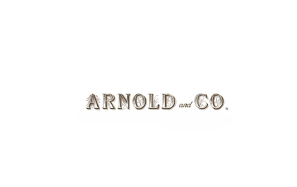 "Arnold and Co. logo featuring vintage-style serif typography in faded brown tones, giving a classic and rustic look."