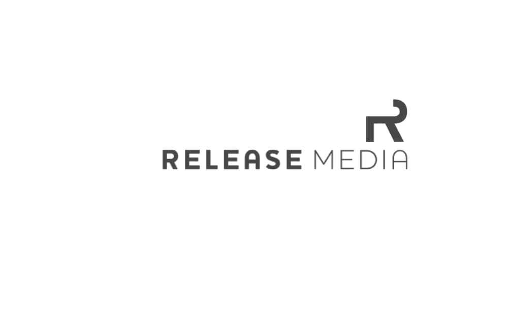 Minimalist logo with “RELEASE MEDIA” in gray uppercase letters and a modern, abstract “R” icon to the right.