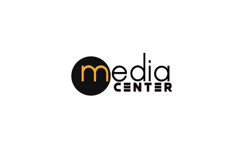Media Center logo with the letter “m” inside a black circle in orange, followed by the word “edia” and bold “CENTER” below, showing a modern and creative media identity.